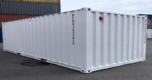 One-trip shipping container next to used cargo-worthy container — JK Shipping LLC